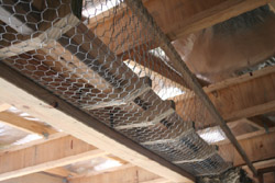 Initial work over the straw bale window opening with the lintel, droppers and wire netting in place.